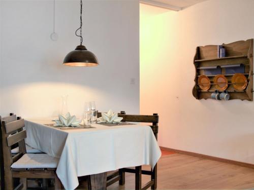 a dining room with a white table with chairs at Apartment Chesa Ova Cotschna 205 by Interhome in St. Moritz