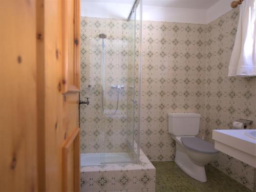 a bathroom with a shower and a toilet at Apartment Chesa La Sajetta 12 by Interhome in Surlej