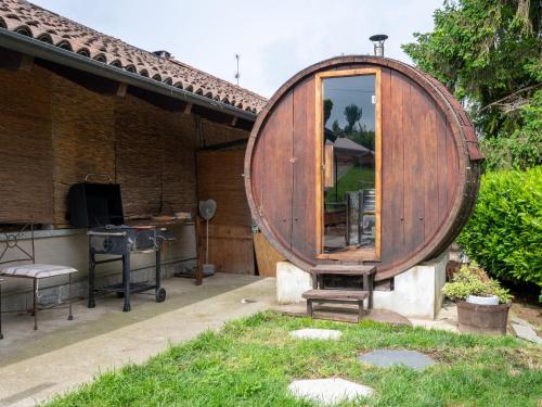 a large wooden barrel sitting outside of a house at Apartment Ca' Marianna by Interhome in Roatto
