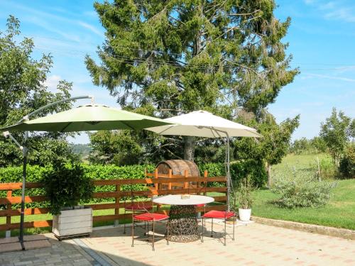 a table and two chairs under an umbrella at Apartment Ca' Marianna by Interhome in Roatto