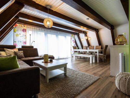 a living room with a couch and a table at Holiday Home Ferienwohnpark Immenstaad-1 by Interhome in Immenstaad am Bodensee