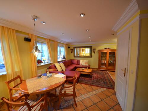 a living room with a table and a couch at Holiday Home Lotsenhaus by Interhome in Groß Zicker