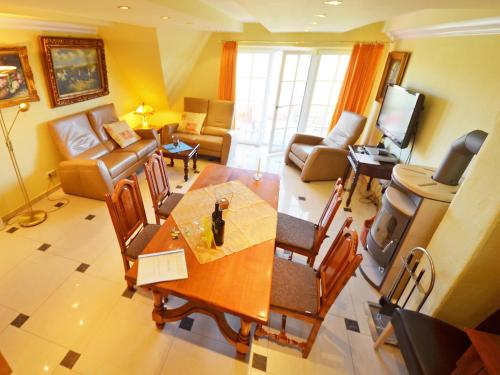 a living room with a dining table and a living room at Apartment Sonnenkliff-3 by Interhome in Groß Zicker