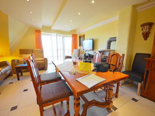 a living room with a wooden table and chairs at Apartment Sonnenkliff-3 by Interhome in Groß Zicker