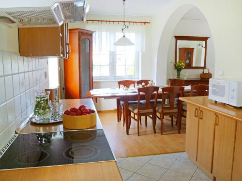 a kitchen and dining room with a table and chairs at Holiday Home Mały dworek by Interhome in Łeba