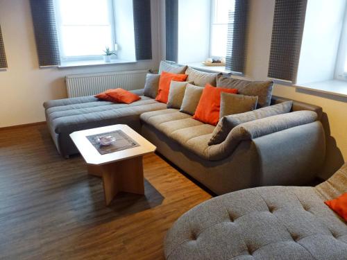 a living room with a couch and a table at Apartment Schuler by Interhome in Unterkirnach