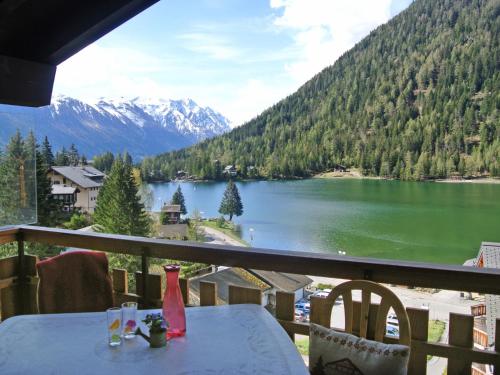 a table on a balcony with a view of a lake at Apartment Parc B 431 by Interhome in Champex
