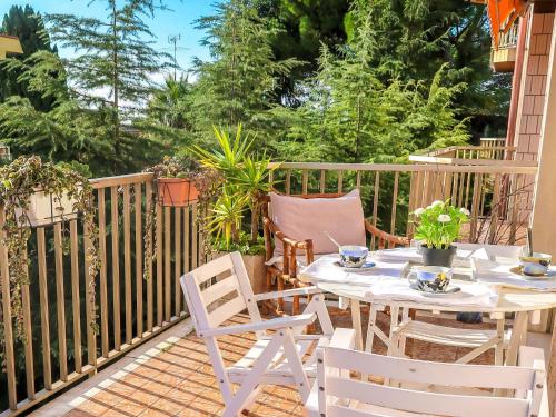 a patio with a table and chairs on a fence at Apartment Casa Nicoló by Interhome in Poggio