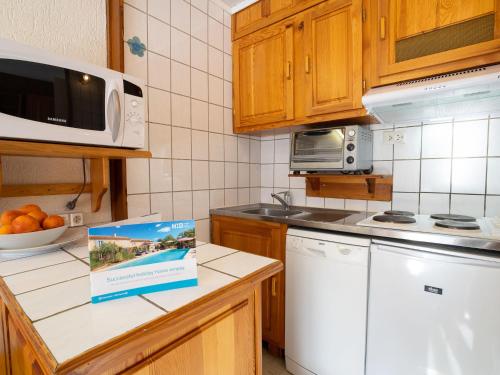 a kitchen with a dishwasher and a box on the counter at Studio Le Slalom - Val Claret-3 by Interhome in Tignes