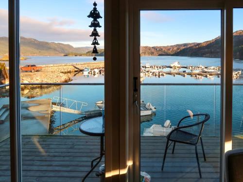 a room with a view of a marina with two chairs at Holiday Home Jektastøo - FJH660 by Interhome in Nordhuglo
