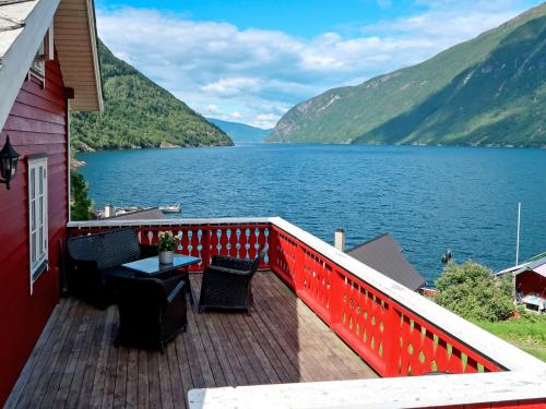 a balcony with a view of a large lake at Holiday Home Johans Maria stova - FJS606 by Interhome in Arnefjord