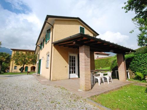 a house with a patio with tables and chairs at Holiday Home Gli Antichi by Interhome in Camaiore