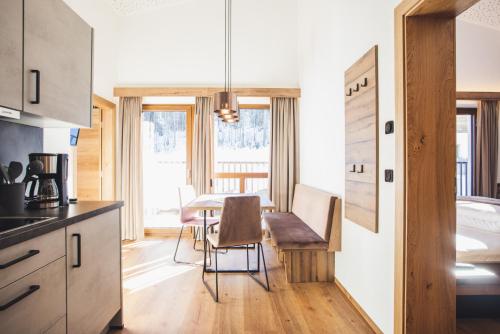 a kitchen with a table and a dining room at Alpenperle Apartments in Ladis
