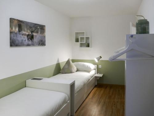 Pokój z dwoma łóżkami i obrazem na ścianie w obiekcie Apartment Chesa Ova Cotschna 306 by Interhome w Sankt Moritz