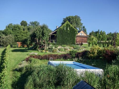 a garden with a swimming pool and a house at Holiday Home Jura dla Ciebie by Interhome in Cisowa