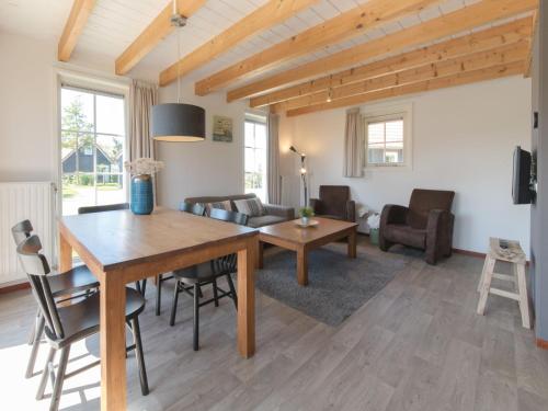 ウェーメルディンゲにあるHoliday Home Zeeuwse Cottage Wemeldinge-3 by Interhomeの木製のテーブルとソファのあるリビングルーム