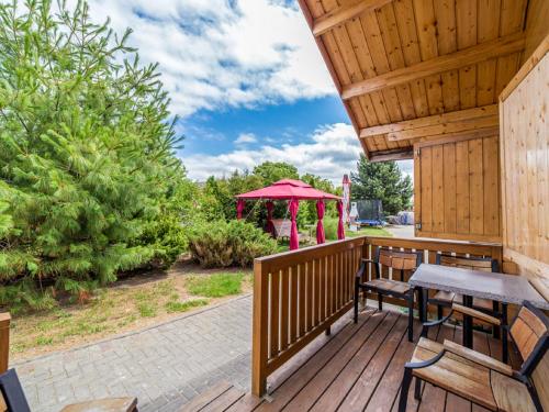 a deck with a picnic table and a gazebo at Holiday Home Onyx-1 by Interhome in Mielno