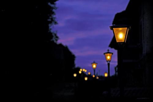 a row of street lights at night at Posada La Solana - Adults Only in Santillana del Mar
