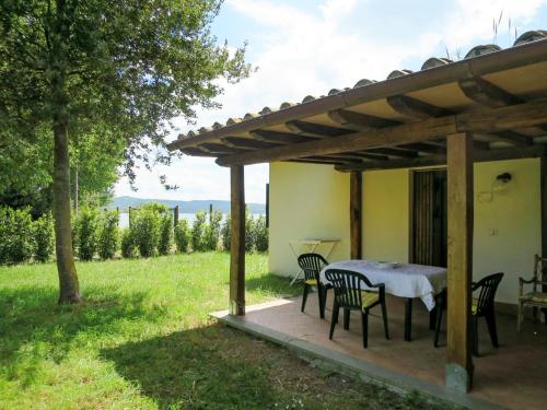 a patio with a table and chairs under a pergola at Holiday Home Chalet del Lago by Interhome in Bolsena