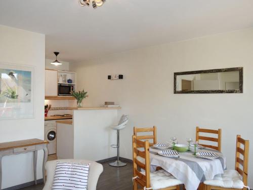 a living room with a table and a kitchen at Apartment Domaine de Clairefontaine-1 by Interhome in Deauville