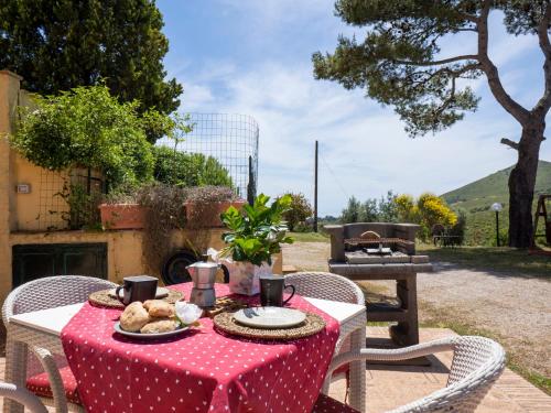a table with a red table cloth with food on it at Apartment Saha by Interhome in Sperlonga