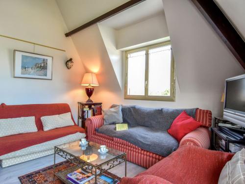 a living room with two couches and a tv at Apartment Marie Antoinette-2 by Interhome in Deauville