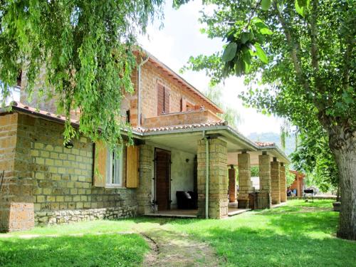 a brick house with a tree in the yard at Apartment Casa Domenico 2 by Interhome in Montefiascone