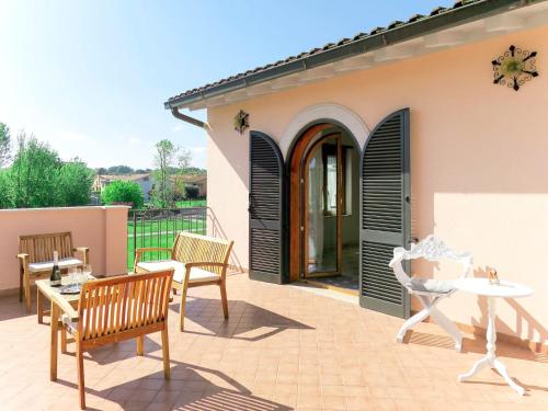 a patio with chairs and a table and a building at Apartment Amalasunta by Interhome in Marta
