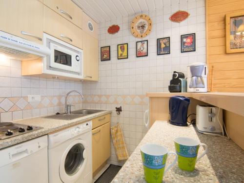 a kitchen with a sink and a washing machine at Apartment Grandes Platières II-2 by Interhome in Tignes