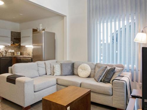 a living room with a couch and a kitchen at Holiday Home Vuokatinlampi 7 a - 2 ski passes incl- in by Interhome in Lahdenperä