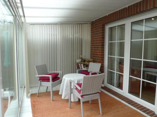 a room with a table and chairs on a balcony at Apartment Seebär by Interhome in Norddeich