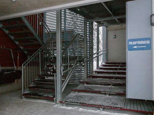 a metal staircase in a building with a sign on it at Holiday Home Yllästar 3 as 509 by Interhome in Äkäslompolo