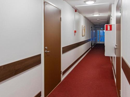 a corridor in an office building with a red carpet at Holiday Home Yllästar 3 as 509 by Interhome in Äkäslompolo