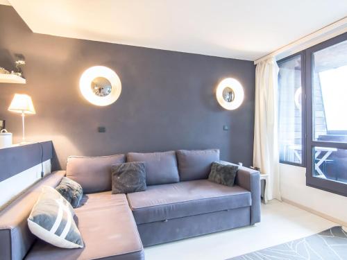 a living room with a couch and a window at Studio Les Marinas-10 by Interhome in Deauville