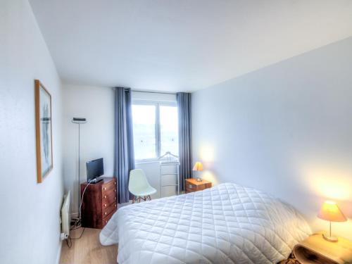 a bedroom with a white bed and a window at Apartment Les Marinas-3 by Interhome in Deauville