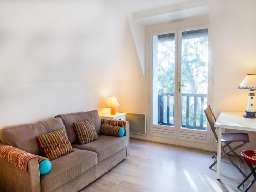 a living room with a couch and a table at Apartment Eden Park by Interhome in Bénerville-sur-Mer