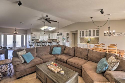 a living room with a large couch and a kitchen at Pool and Lake Havasu Views Gorgeous Desert Escape! in Lake Havasu City