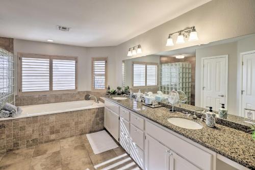 a bathroom with two sinks and a bath tub and a tubermott at Pool and Lake Havasu Views Gorgeous Desert Escape! in Lake Havasu City
