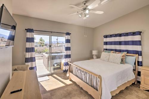 a bedroom with a bed and a sliding glass door at Pool and Lake Havasu Views Gorgeous Desert Escape! in Lake Havasu City