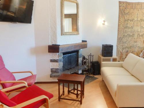 a living room with a couch and a fireplace at Apartment Galaxie 217 by Interhome in Verbier