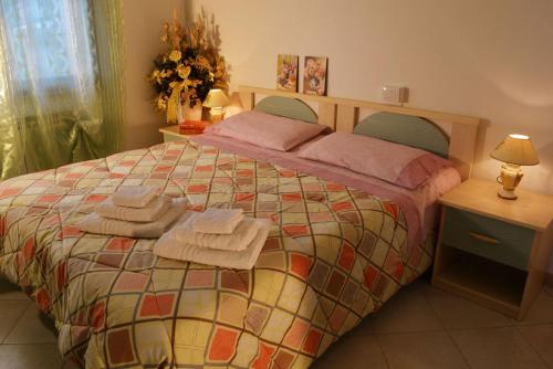 a bedroom with a bed with towels on it at B&B La Collina in Posada