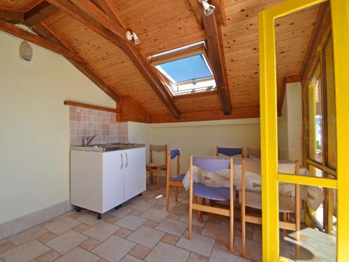 a kitchen with a table and chairs and a window at Holiday Home Kala by Interhome in Sveti Filip i Jakov