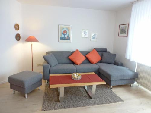 a living room with a couch and a table at Apartment Schwarzwaldblick-26 by Interhome in Obertal