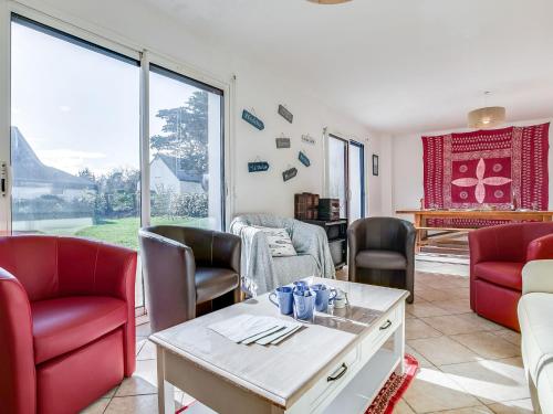 un salon avec des chaises rouges et une table dans l'établissement Holiday Home La Brise by Interhome, à Saint-Pierre-Quiberon