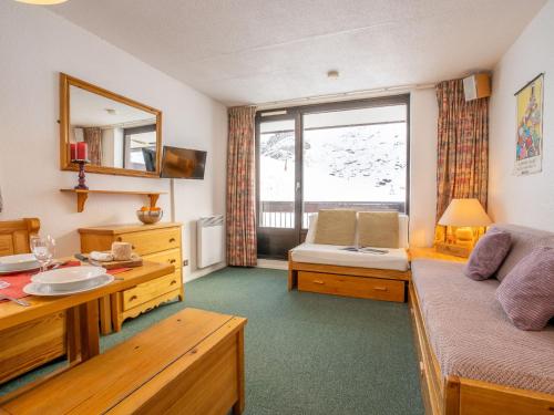 a living room with a couch and a table at Apartment Les Tommeuses - Val Claret-32 by Interhome in Tignes