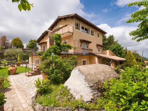 a house with a large rock in front of it at Villa Vista da Rocca di Papa-1 by Interhome in Rocca di Papa