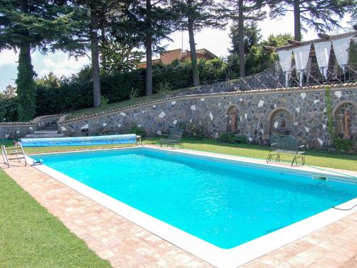 a swimming pool with two chairs in a yard at Villa Vista da Rocca di Papa-1 by Interhome in Rocca di Papa