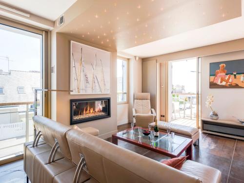 a living room with a couch and a fireplace at Apartment Les Néréïdes-1 by Interhome in Quiberon