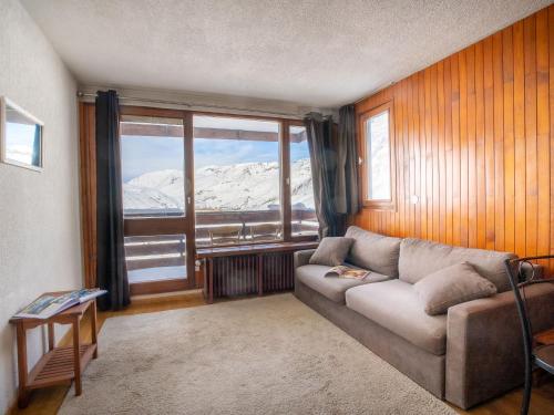 a living room with a couch and a large window at Studio Le Slalom - Val Claret-7 by Interhome in Tignes