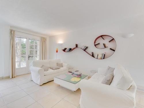 a living room with two white couches and a mirror at Holiday Home Les Parcs de Gassin-9 by Interhome in Saint-Tropez